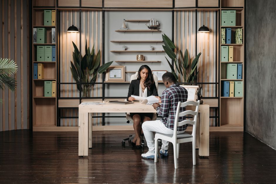 An attorney and client in a consultation, discussing legal documents - immigration attorney for deportation An attorney and client in a consultation, discussing legal documents - immigration attorney for deportation